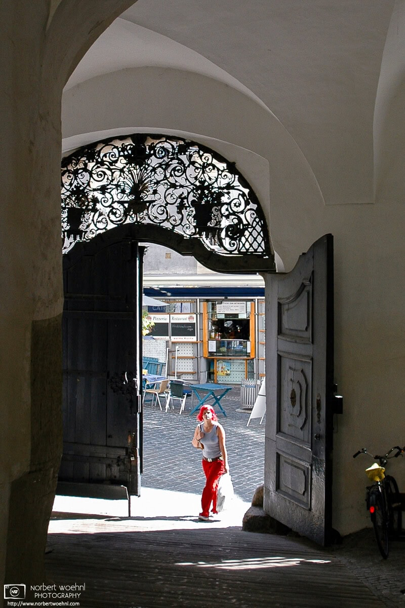 Whilst I was just taking some architectural photos at the beautiful inner yard of Palais Saurau in Graz, Austria, a woman with striking red hair walked in. © 2004 Norbert Woehnl Photography.