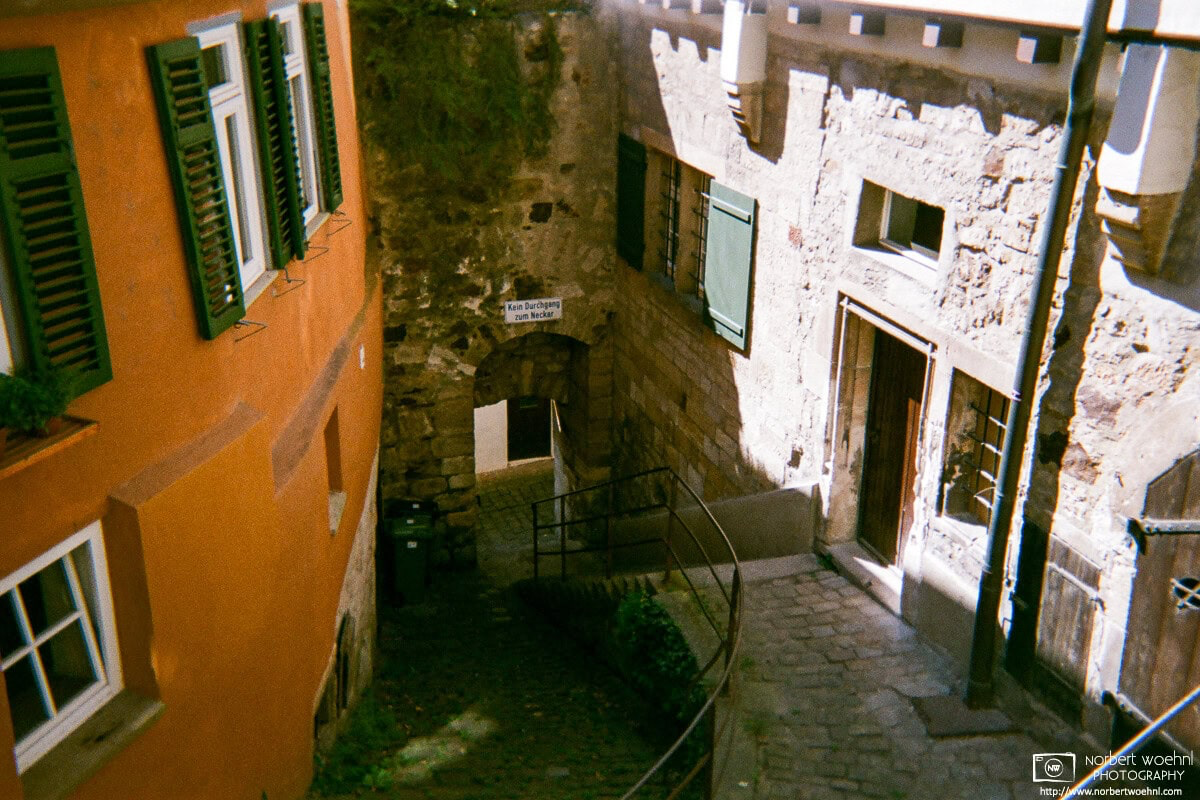 In the historic city center of Tübingen, Germany, this steep and narrow alleyway leads downwards to a former bath near the Neckar River. © 2018 Norbert Woehnl Photography.