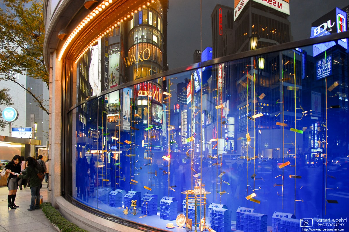 A blue-hour reflection off the curved corner window of Wako Department Store in the Ginza district of Tokyo, Japan. © 2006 Norbert Woehnl Photography.