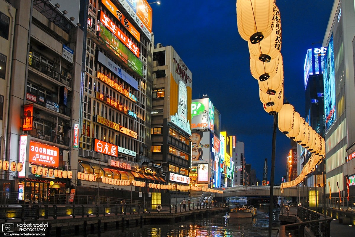 An evening perspective along the Dōtonbori Canal in Osaka, Japan. Historically a theater district, Dotonbori is now a popular nightlife and entertainment area. © 2010 Norbert Woehnl Photography.