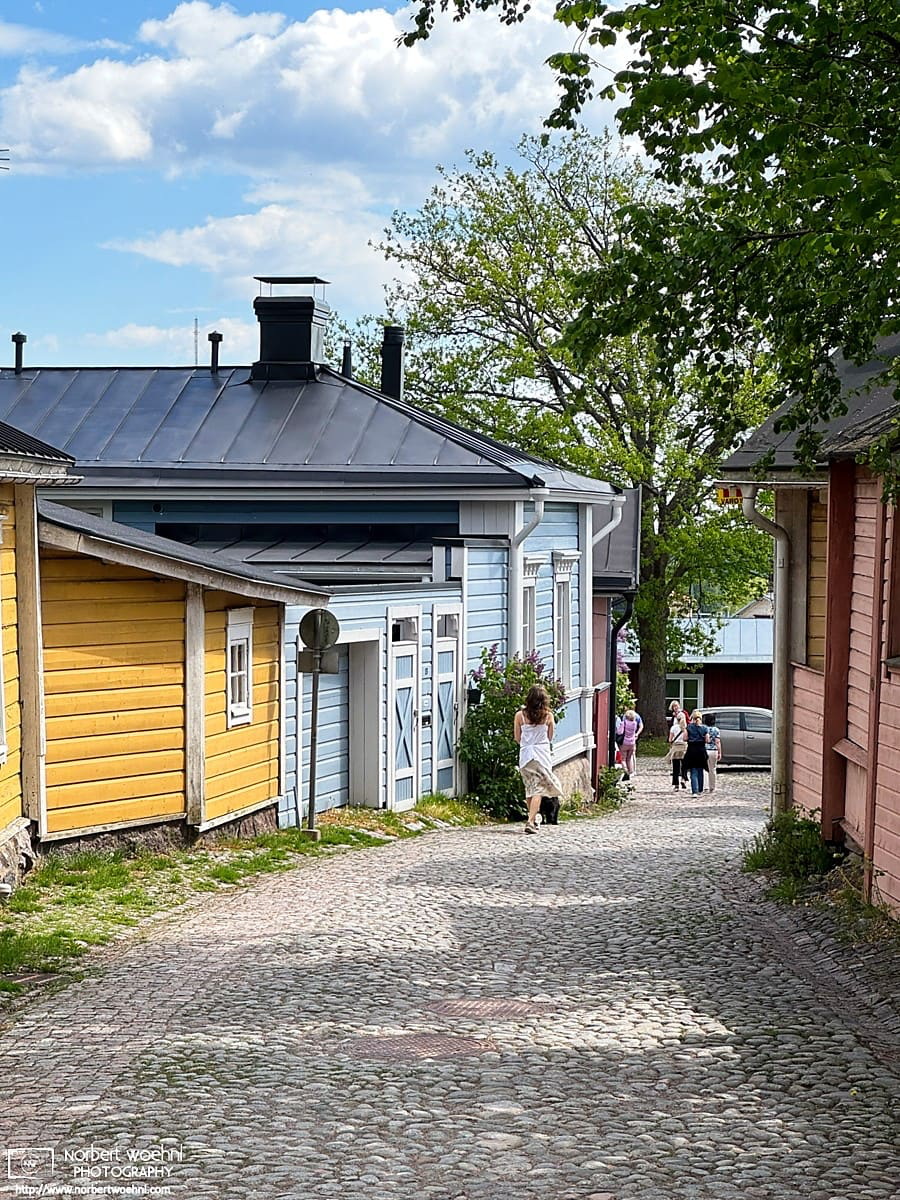 Scene of colorful wooden buildings in the historic district of Porvoo, Finland. © 2026 Norbert Woehnl Photography.