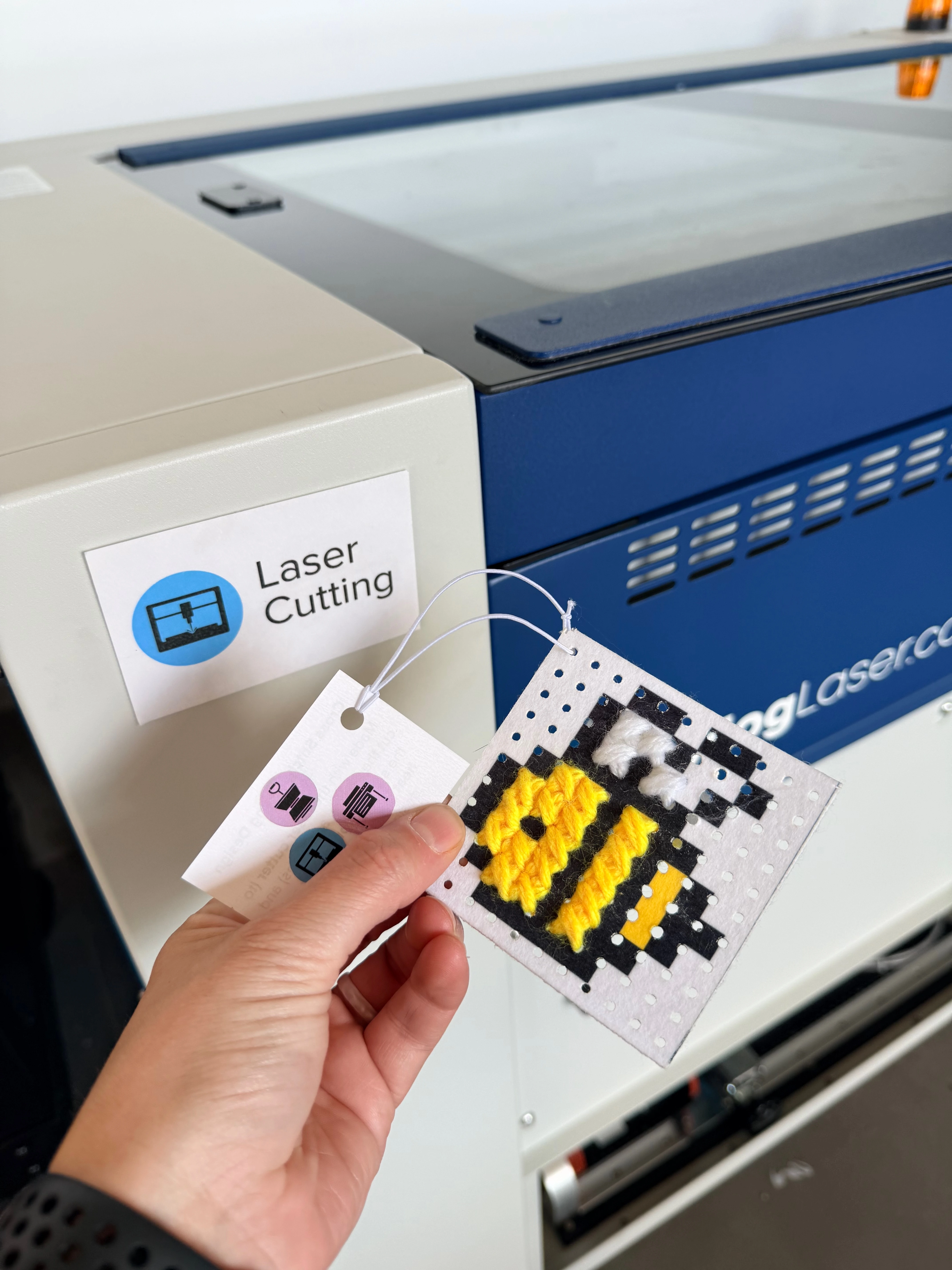 the example is held up in front of the laser cutter