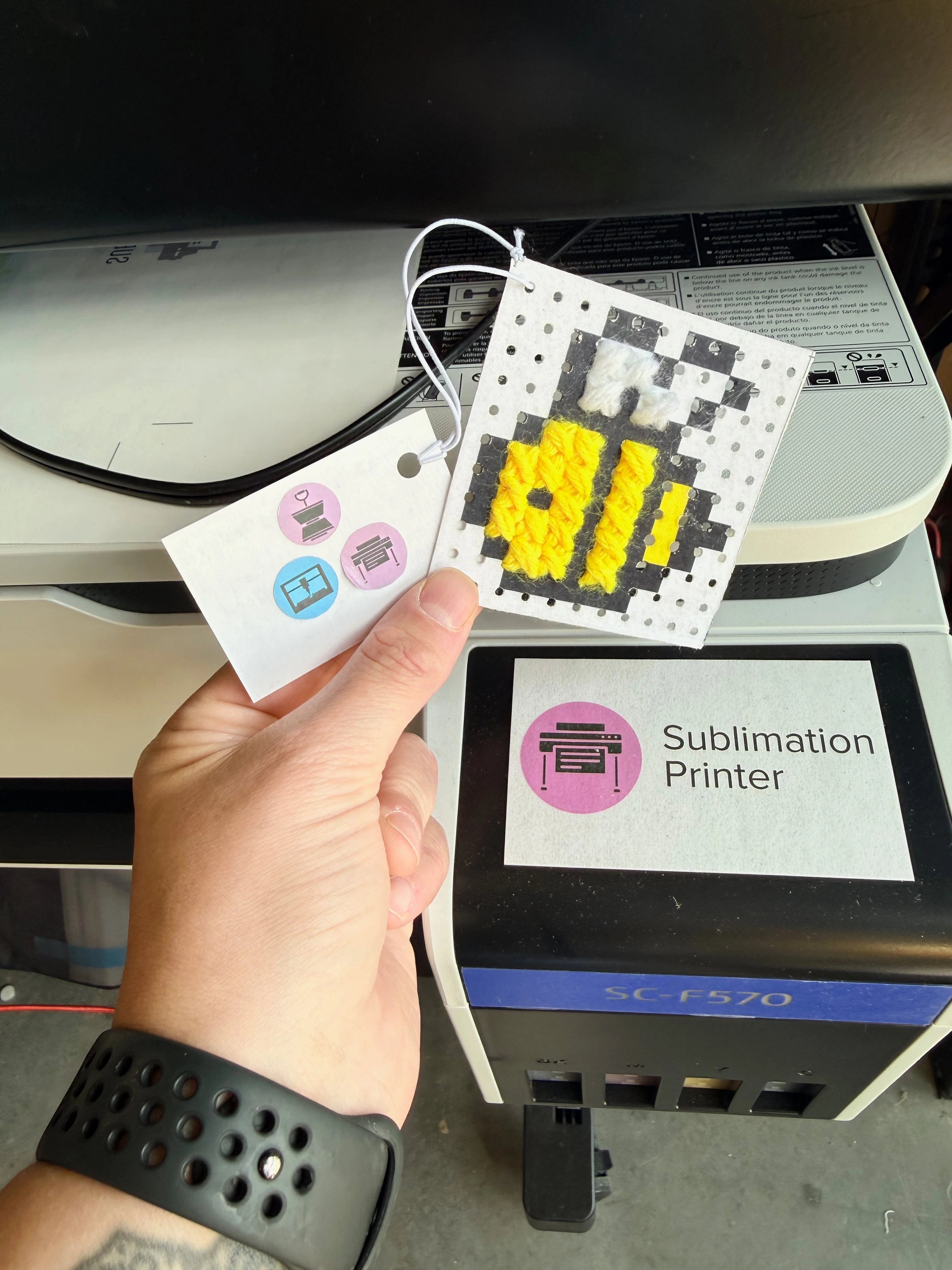 the example is held up in front of the sublimation printer.
